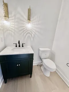 a living room with furniture chandelier and a fireplace