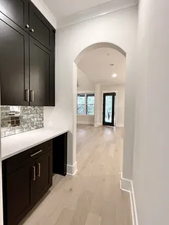 a kitchen with stainless steel appliances kitchen island granite countertop a sink a stove and a wooden floors