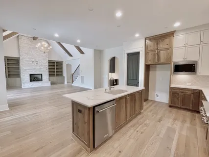 a kitchen with stainless steel appliances granite countertop a stove a sink and a refrigerator