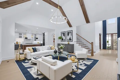 an empty room with wooden floor fireplace and windows