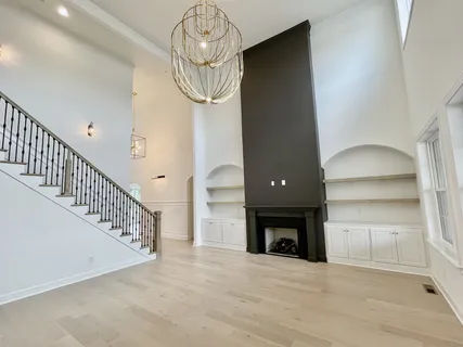 a living room with fireplace furniture and a large window