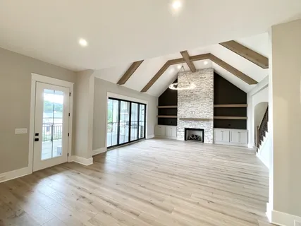 a kitchen with white cabinets and a window