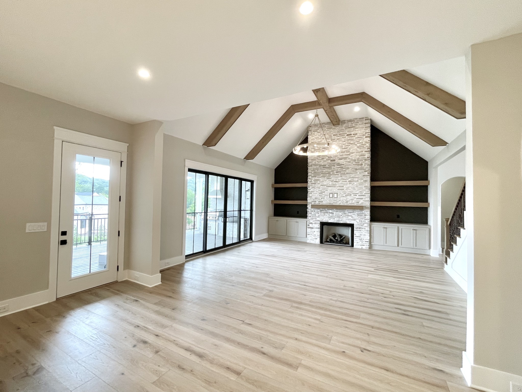 9914 Elland Road Brentwood, TN 37027 - Photo 45 of 64 an empty room with wooden floor fireplace and windows