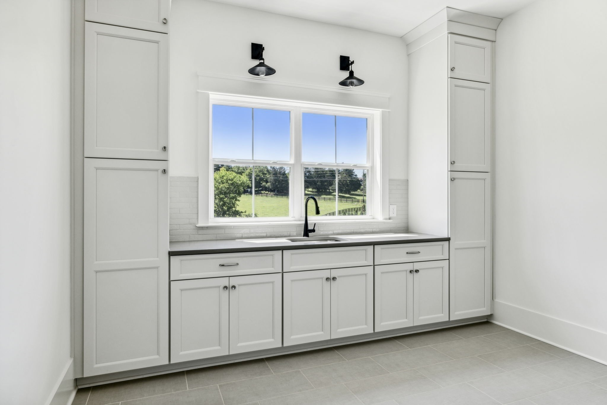 9914 Elland Road Brentwood, TN 37027 - Photo 54 of 64 a kitchen with white cabinets and a window