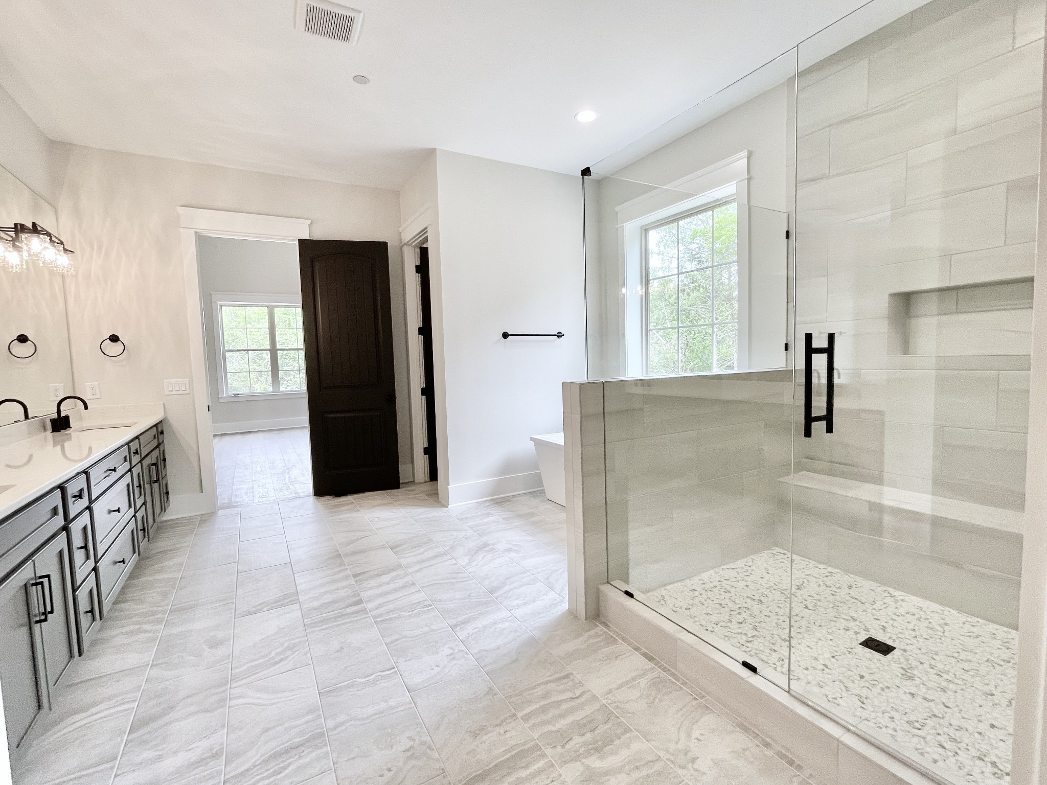 9914 Elland Road Brentwood, TN 37027 - Photo 61 of 64 a bathroom with a glass shower door a sink and a shower