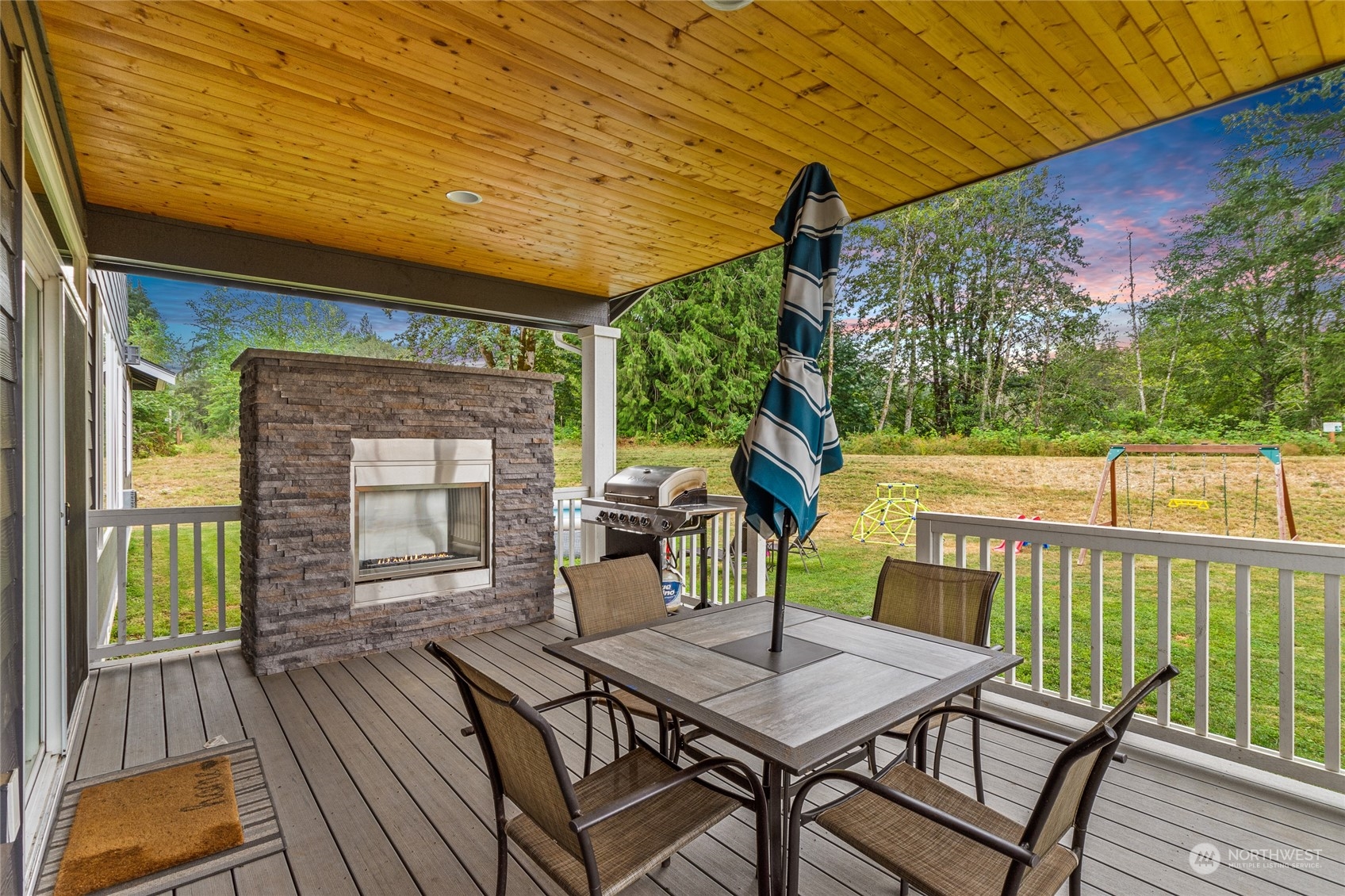 3522 Creswell Road Snohomish, WA 98290 - Photo 32 of 40 a view of a patio with table and chairs potted plants with wooden floor and fence