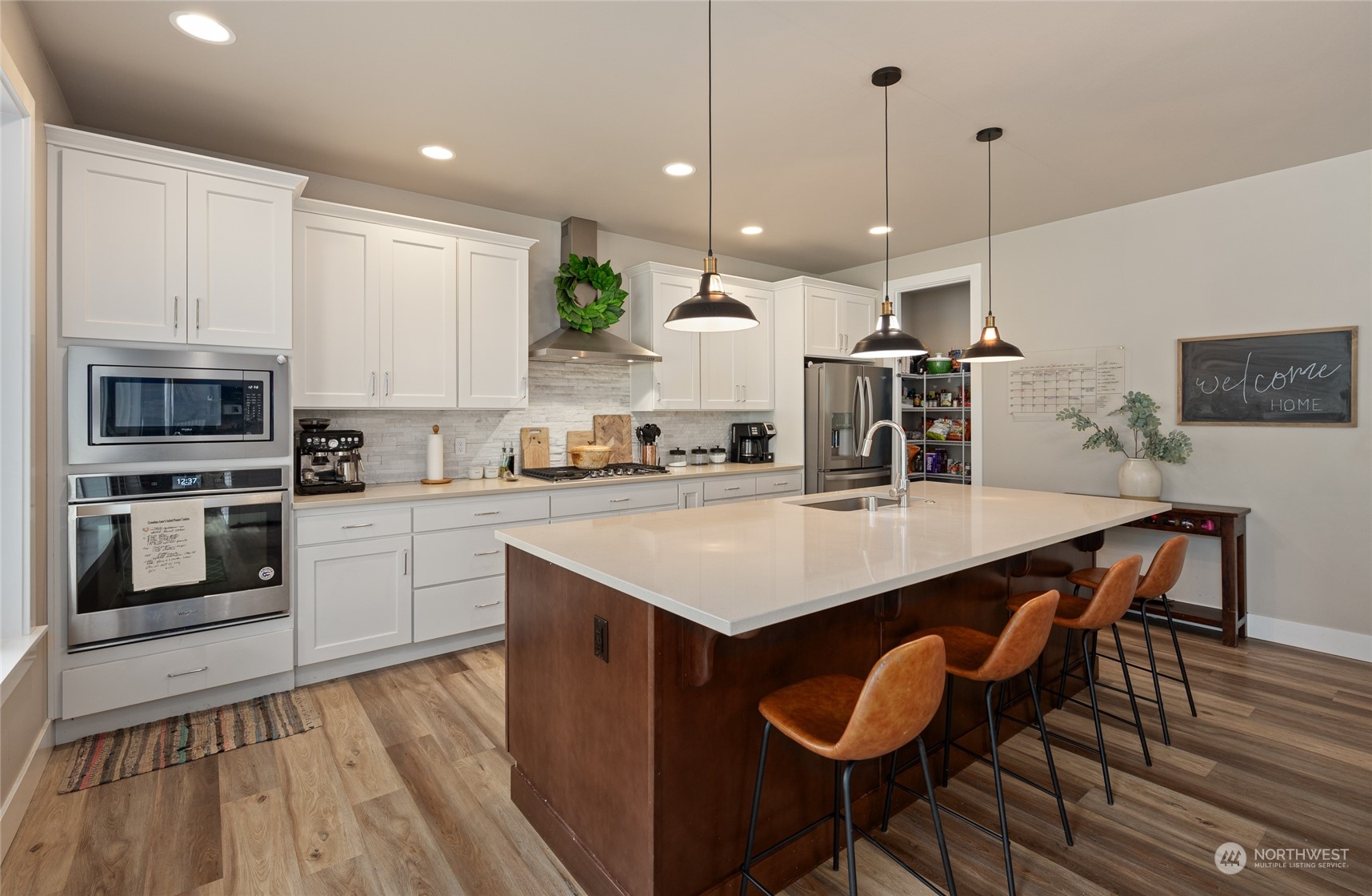 3522 Creswell Road Snohomish, WA 98290 - Photo 10 of 40 a kitchen with granite countertop a table chairs stainless steel appliances and wooden floor