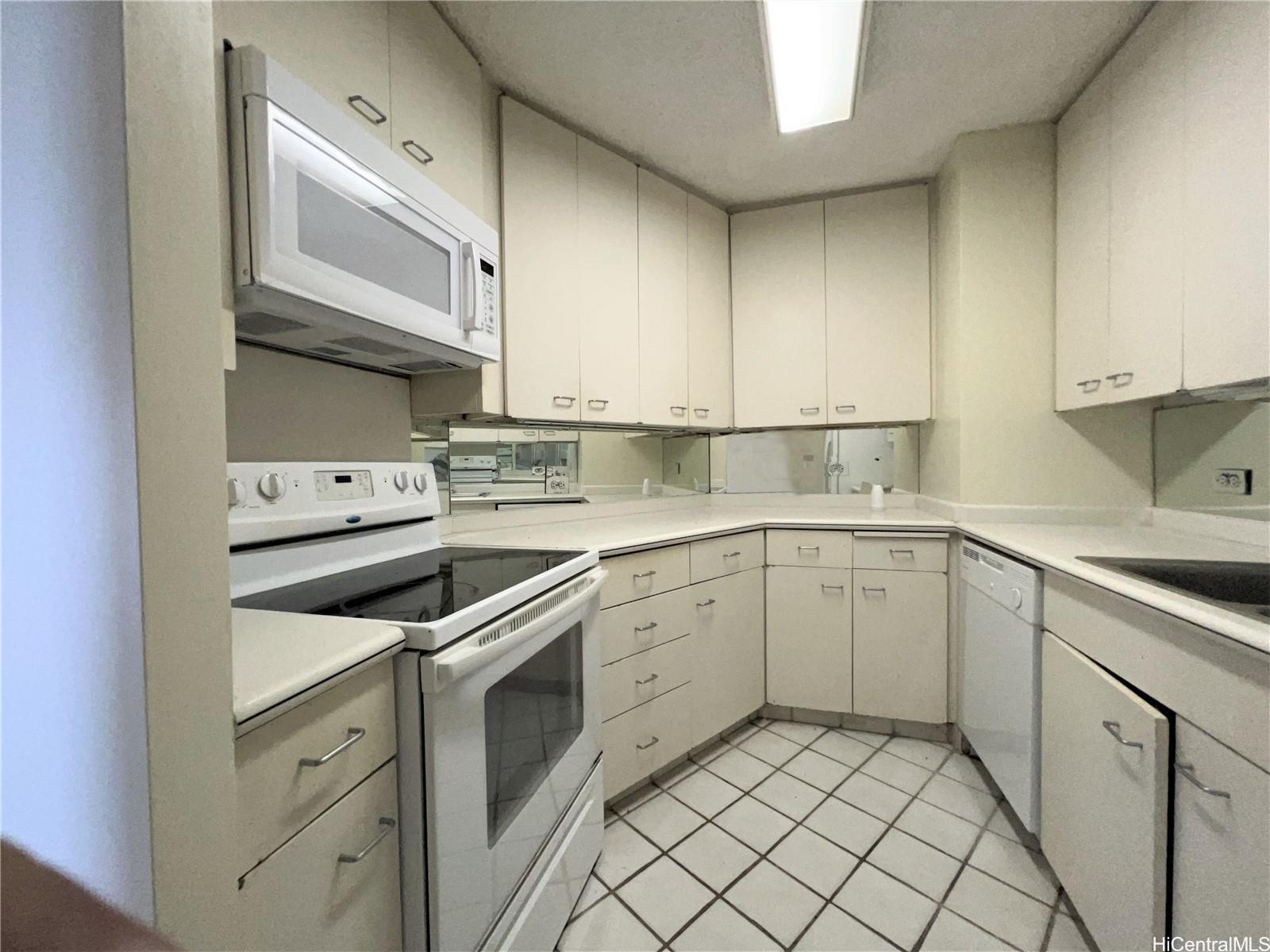 1860 Ala Moana Boulevard, Unit 902B Honolulu, HI 96815 - Photo 3 of 15 a kitchen with cabinets appliances a sink and a counter top