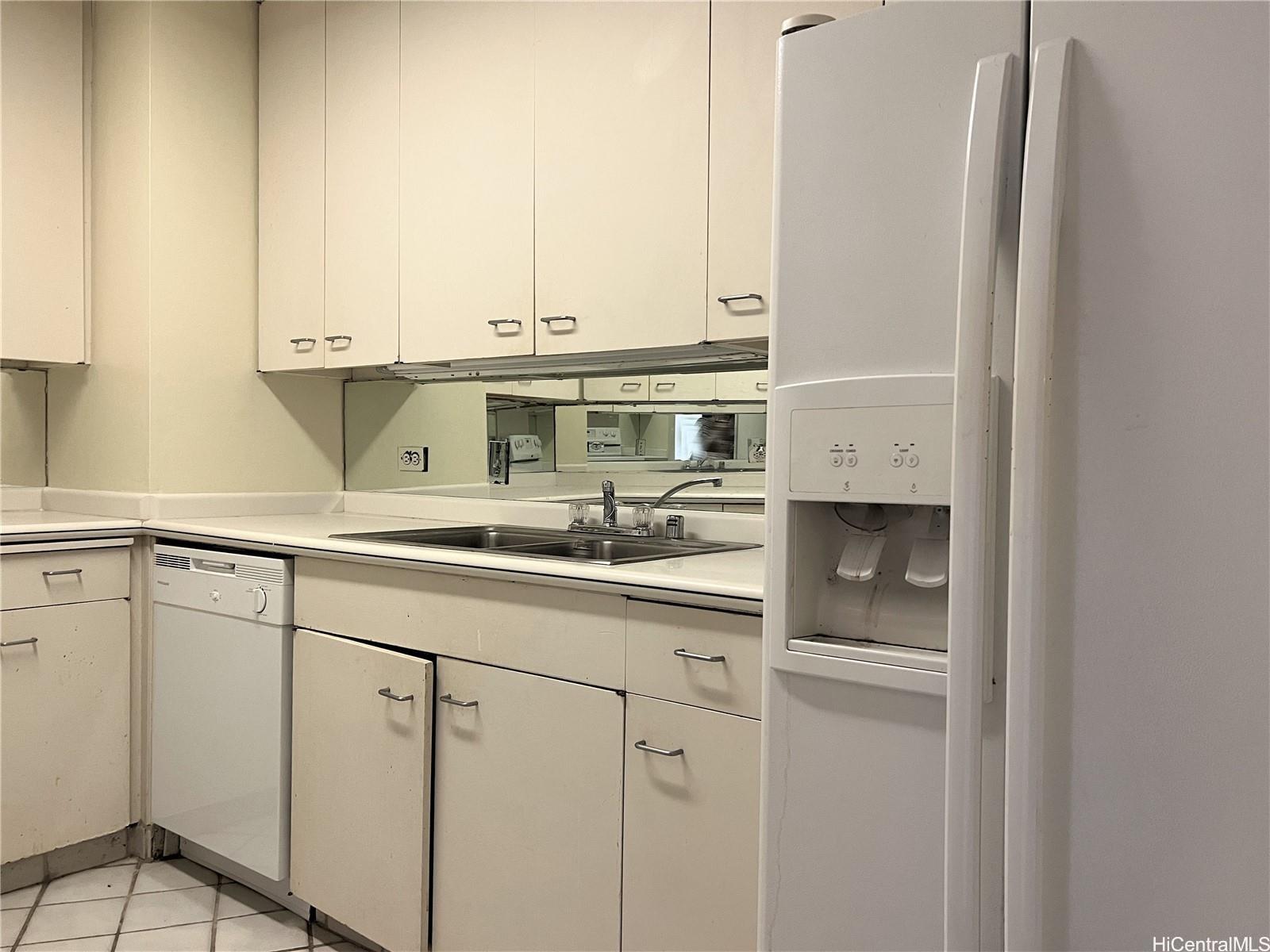 1860 Ala Moana Boulevard, Unit 902B Honolulu, HI 96815 - Photo 4 of 15 a kitchen with stainless steel appliances a sink and cabinets