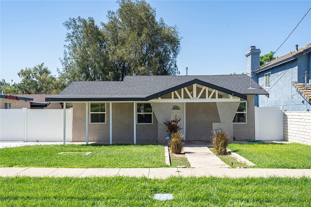 2850 Woodbine Street Riverside, CA 92507 - Photo 1 of 1 a front view of a house with a yard and porch
