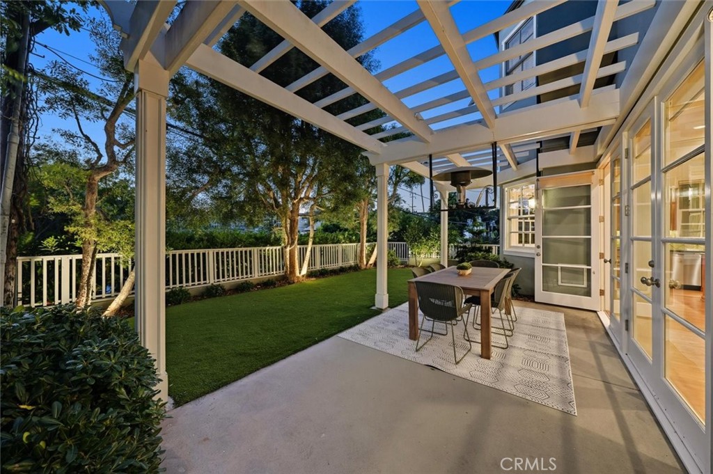 2909 Maple Avenue Manhattan Beach, CA 90266 - Photo 2 of 57 a view of a patio with table and chairs potted plants with wooden floor and fence