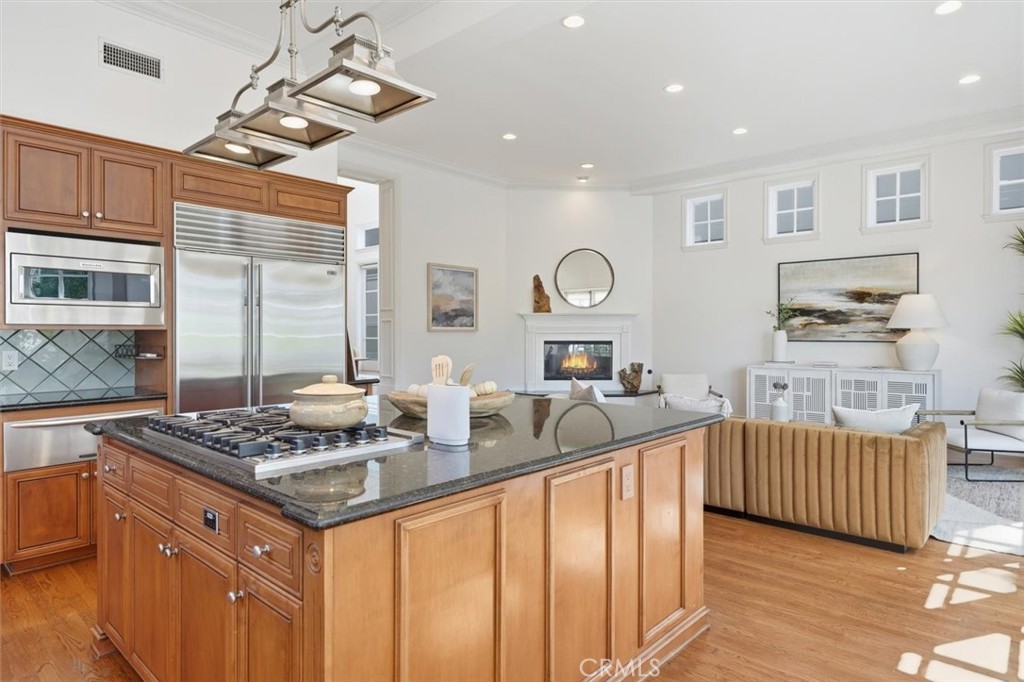 2909 Maple Avenue Manhattan Beach, CA 90266 - Photo 23 of 57 a kitchen that has a lot of cabinets in it and wooden floor