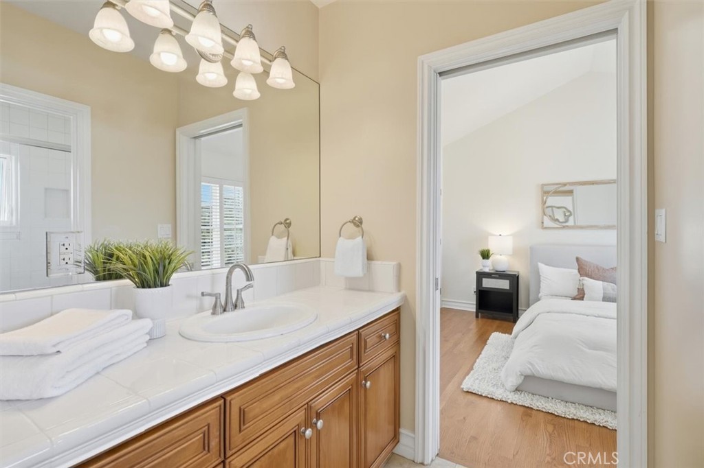 2909 Maple Avenue Manhattan Beach, CA 90266 - Photo 42 of 57 a en suite bathroom with a granite countertop sink a mirror and a shower