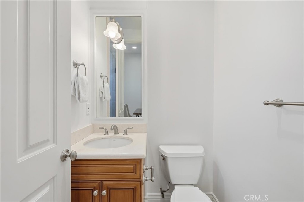 2909 Maple Avenue Manhattan Beach, CA 90266 - Photo 5 of 57 a bathroom with a granite countertop sink toilet and a mirror