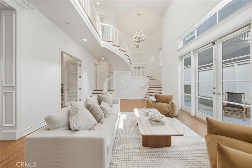 2909 Maple Avenue Manhattan Beach, CA 90266 - Photo 6 of 57 a living room with furniture and a chandelier