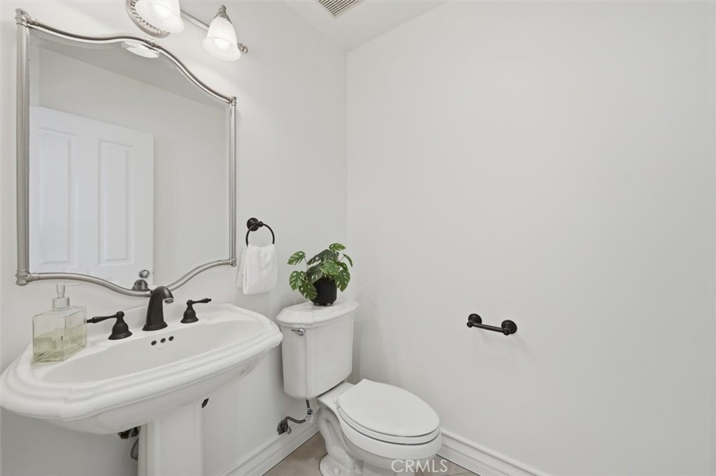 2909 Maple Avenue Manhattan Beach, CA 90266 - Photo 9 of 57 a bathroom with a sink mirror vanity and toilet