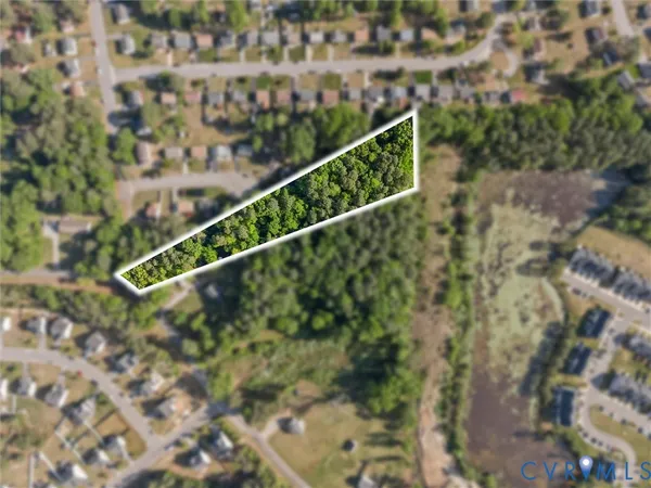 an aerial view of residential houses with green space