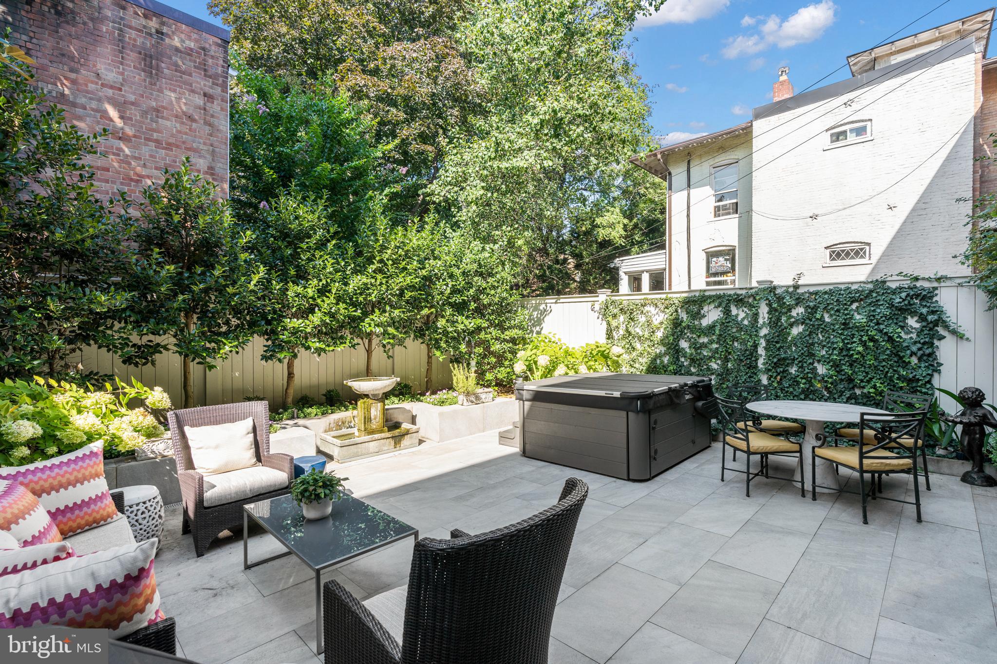 3323 R Street Northwest Washington, DC 20007 - Photo 51 of 54 Holly trees and a flower bed line the back garden
