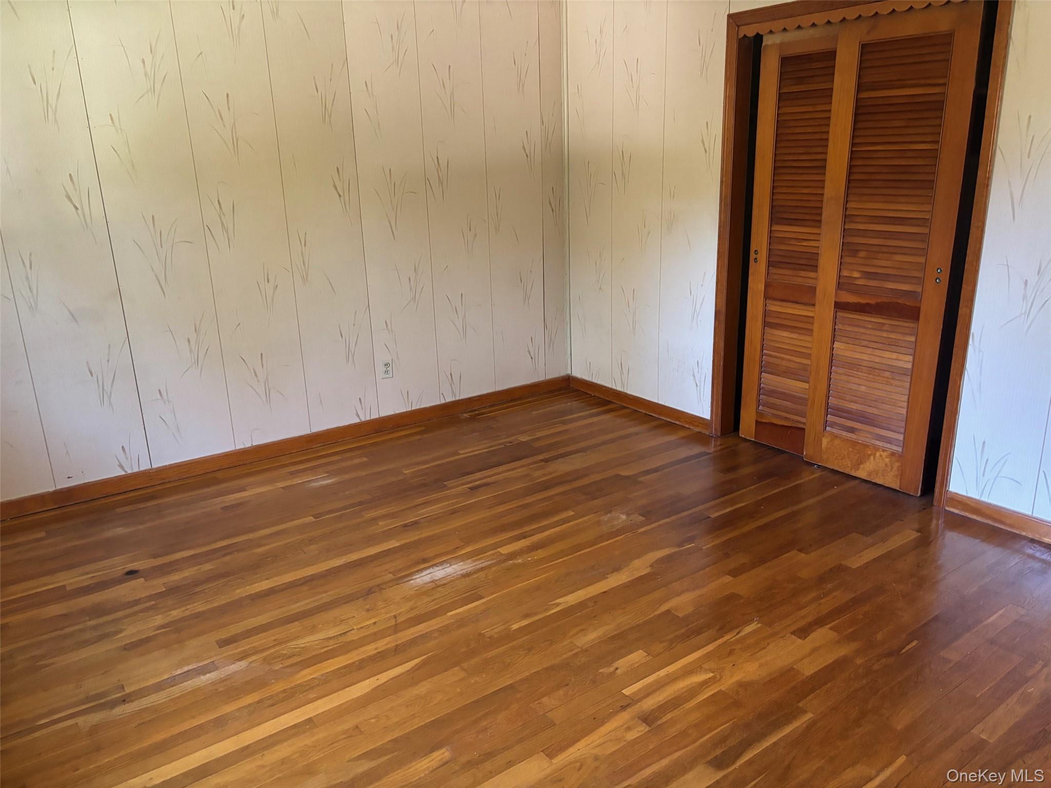 10 13th Avenue West Babylon, NY 11704 - Photo 12 of 33 a view of an empty room with wooden floor and a window