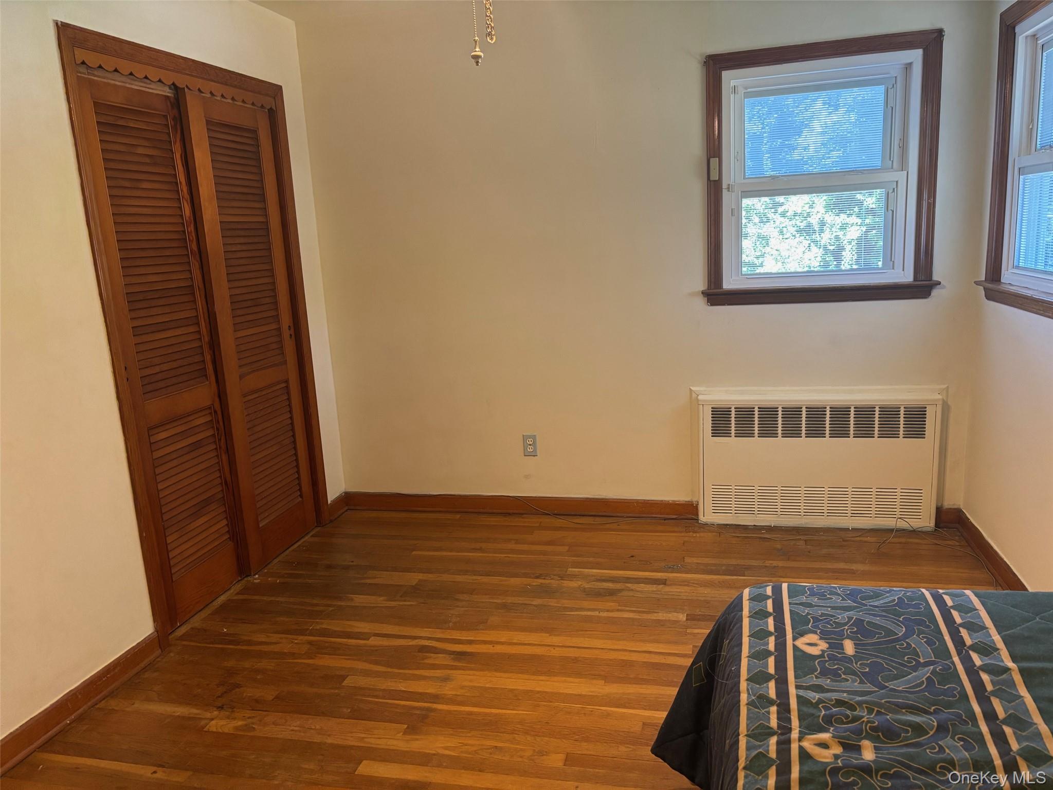 10 13th Avenue West Babylon, NY 11704 - Photo 14 of 33 a view of an empty room with wooden floor and a window