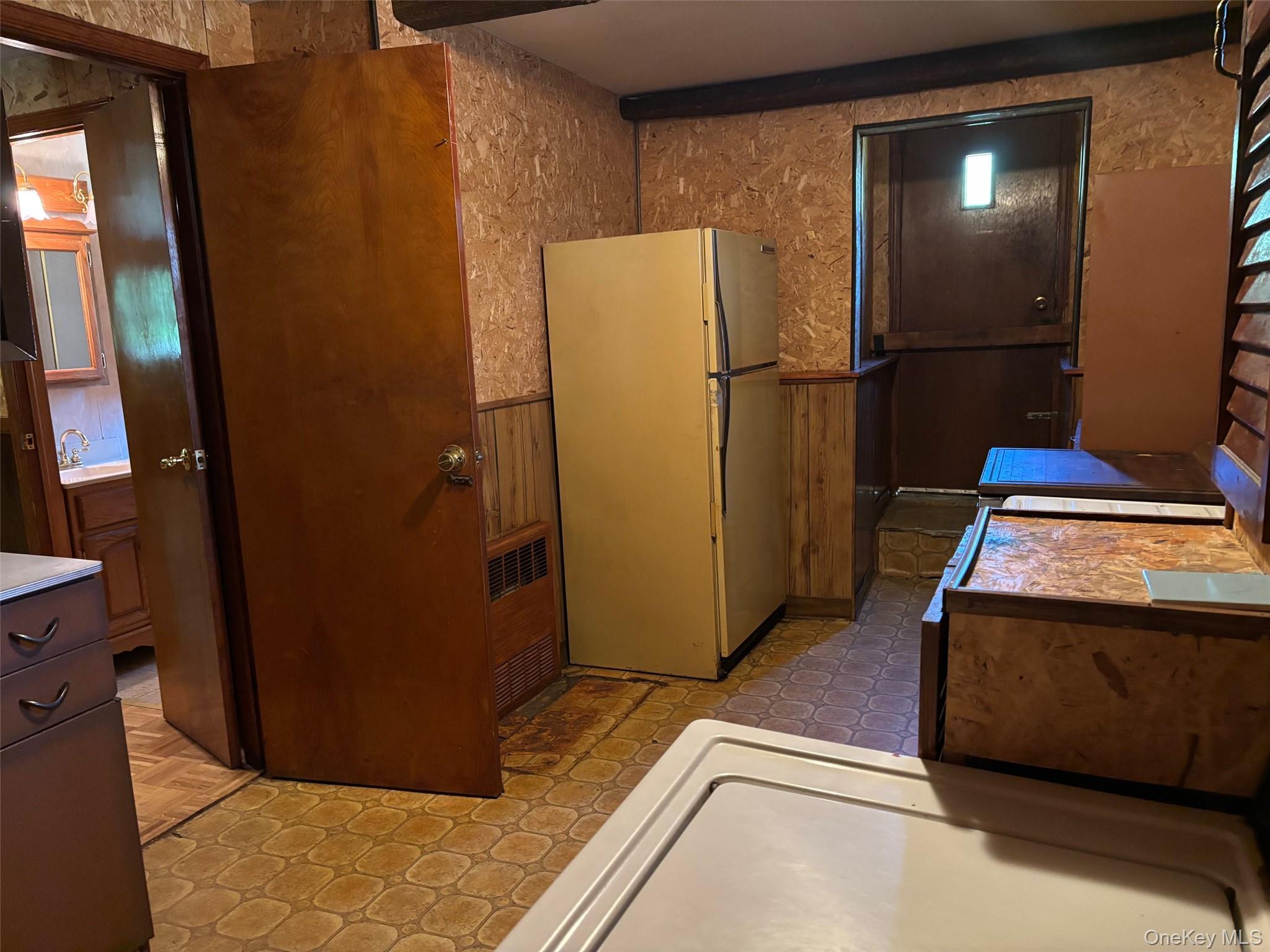 10 13th Avenue West Babylon, NY 11704 - Photo 22 of 33 a view of a refrigerator in kitchen and an empty room