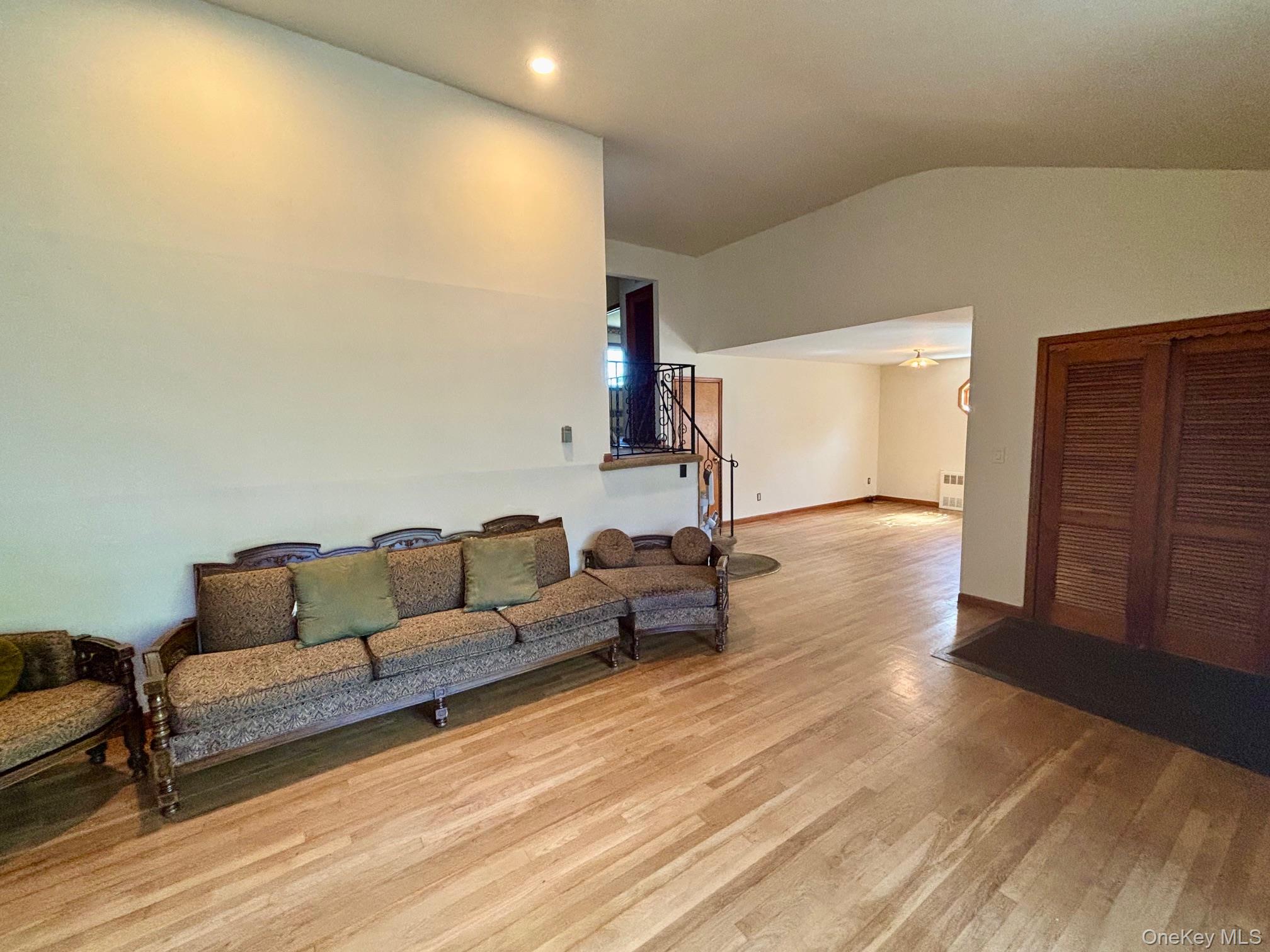 10 13th Avenue West Babylon, NY 11704 - Photo 6 of 33 a living room with couches and kitchen view with wooden floor
