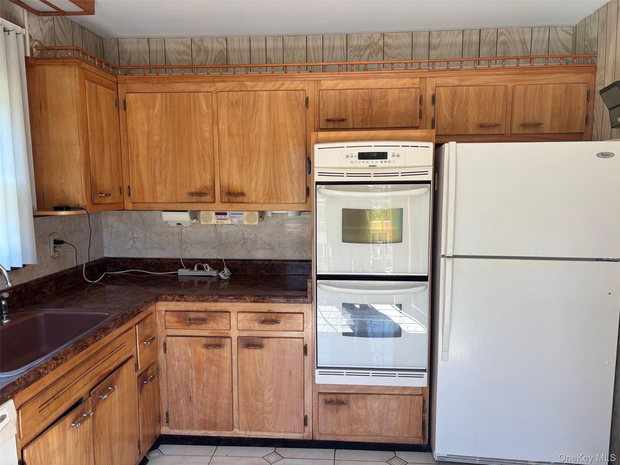 10 13th Avenue West Babylon, NY 11704 - Photo 10 of 33 a kitchen with a stove a refrigerator and a sink