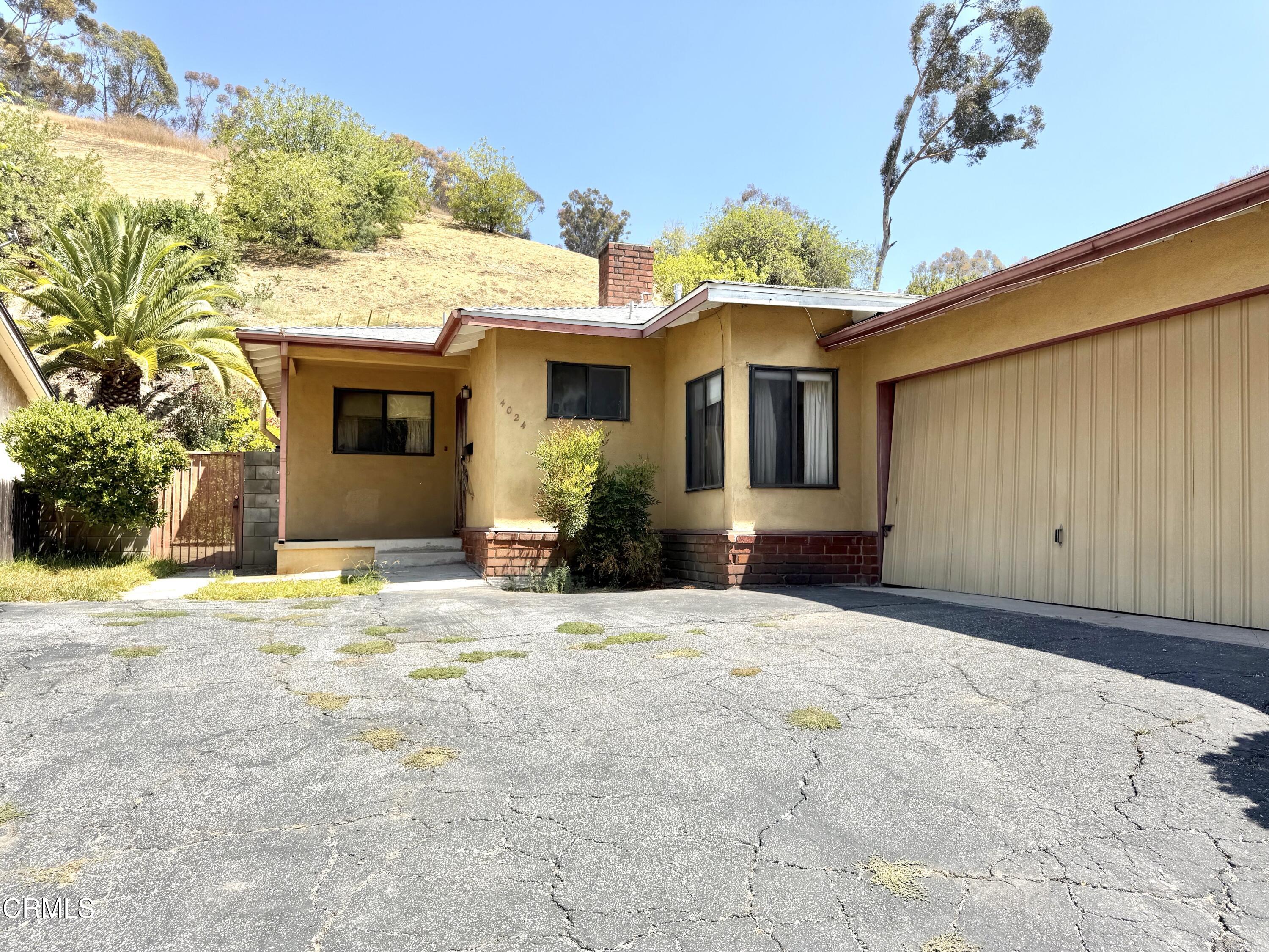 4024 Monterey Road Los Angeles, CA 90032 - Photo 1 of 1 a front view of a house with a yard and garage