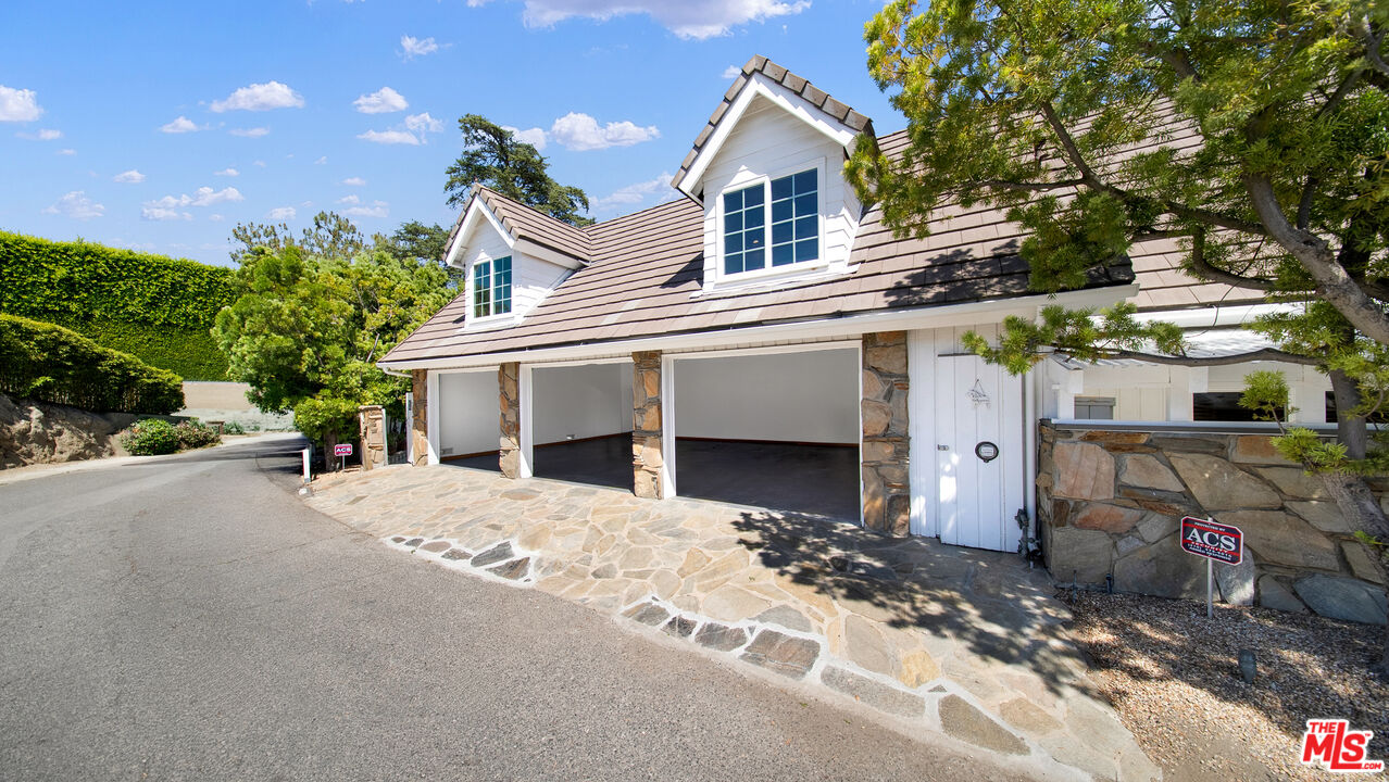 2312 Kimridge Road Beverly Hills, CA 90210 - Photo 33 of 60 a front view of a house with a yard