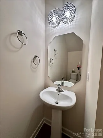 a view of a hallway with wooden cabinets