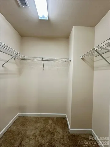 a view of an empty room and window chandelier fan