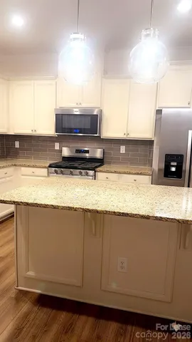 a stove top oven sitting inside of a kitchen