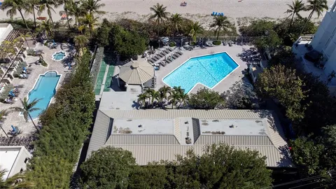 an aerial view of a house with a garden and swimming pool
