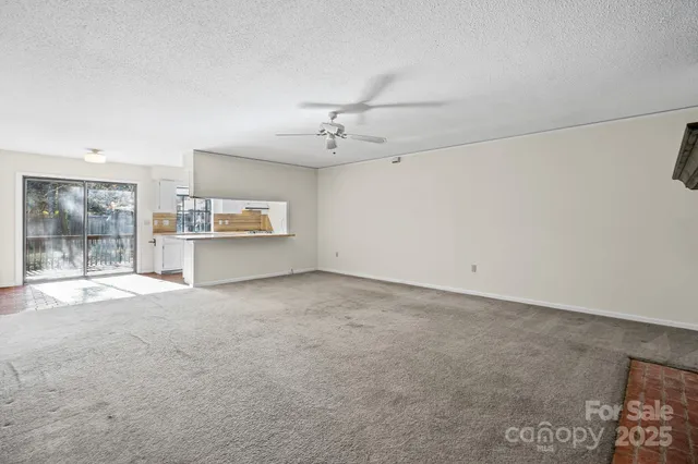 a view of a kitchen with a sink and a refrigerator