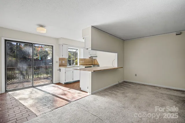 a kitchen with a refrigerator and window