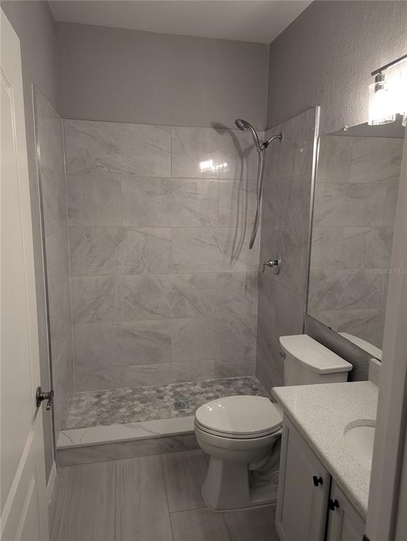 903 Normandy Trace Road Tampa, FL 33602 - Photo 6 of 14 a bathroom with a shower a toilet and a sink