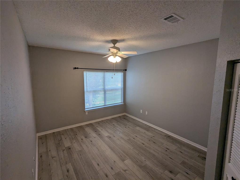 903 Normandy Trace Road Tampa, FL 33602 - Photo 8 of 14 wooden floor in an empty room with a window