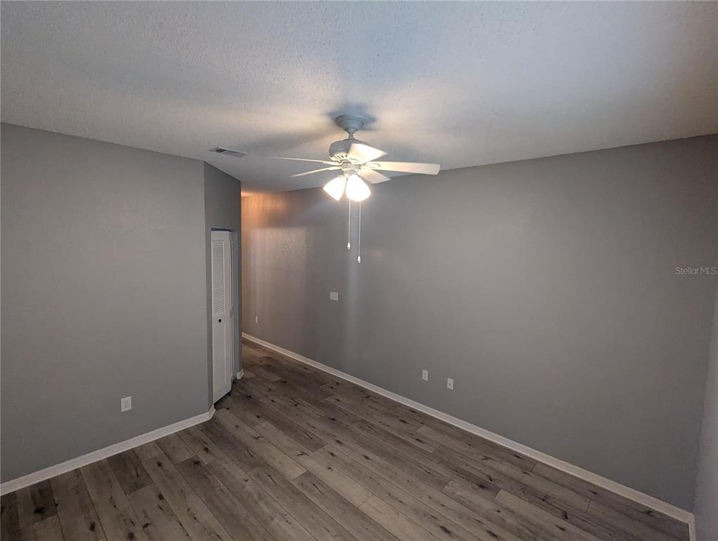 903 Normandy Trace Road Tampa, FL 33602 - Photo 9 of 14 wooden floor in an empty room with a window
