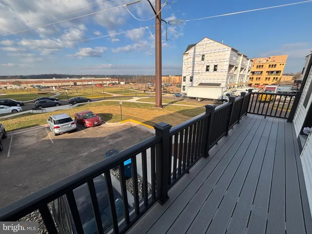 a view of a balcony with wooden floor