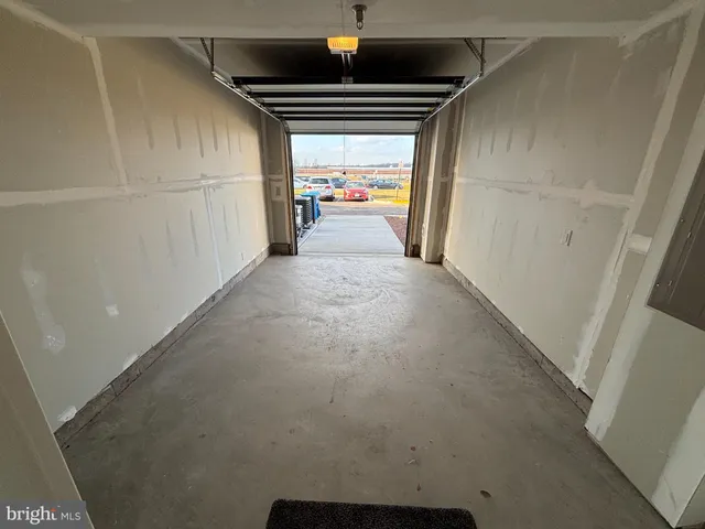 a view of a hallway to a livingroom with furniture