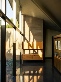 a living room with a floor to ceiling window and wooden floor