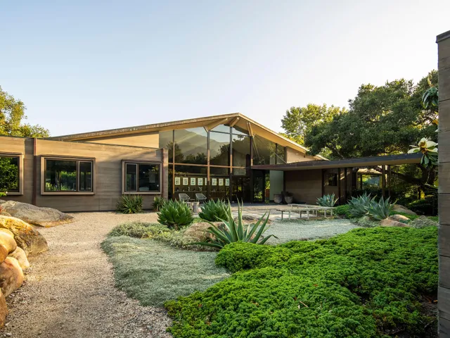 a front view of house with yard outdoor seating and barbeque oven