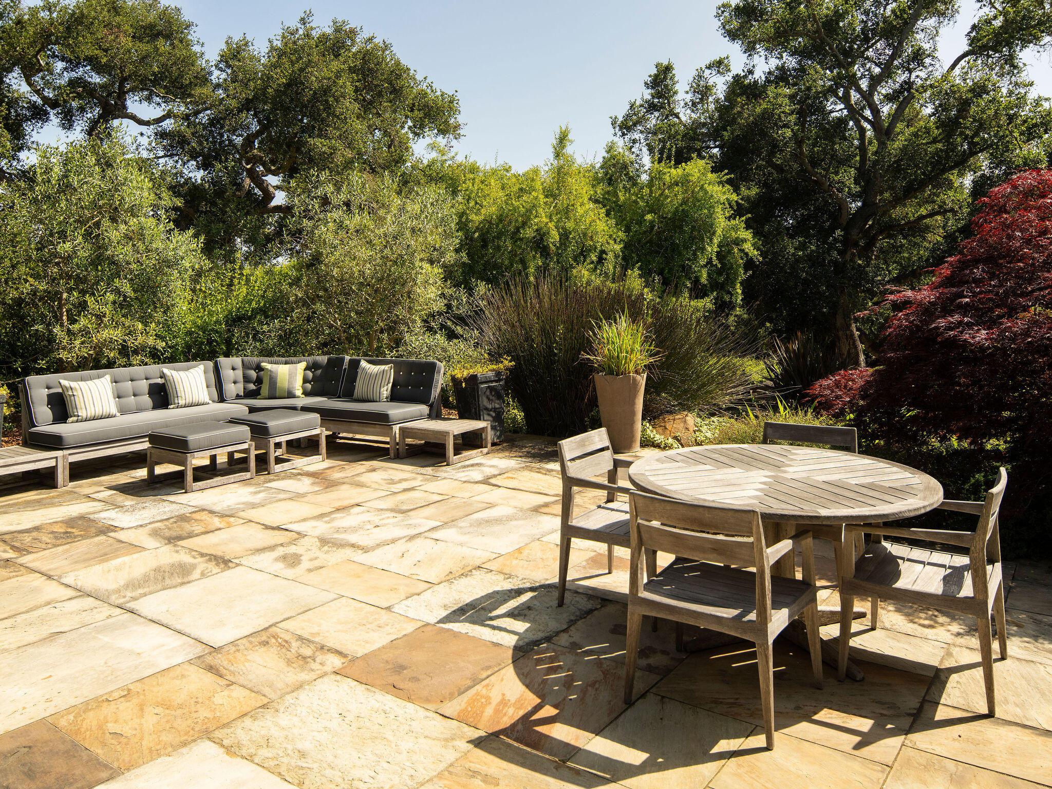 650 San Ysidro Road Montecito, CA 93108 - Photo 36 of 54 a view of a patio with table and chairs and potted plants with wooden floor and fence