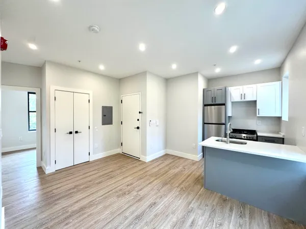 a kitchen with stainless steel appliances a refrigerator sink and cabinets