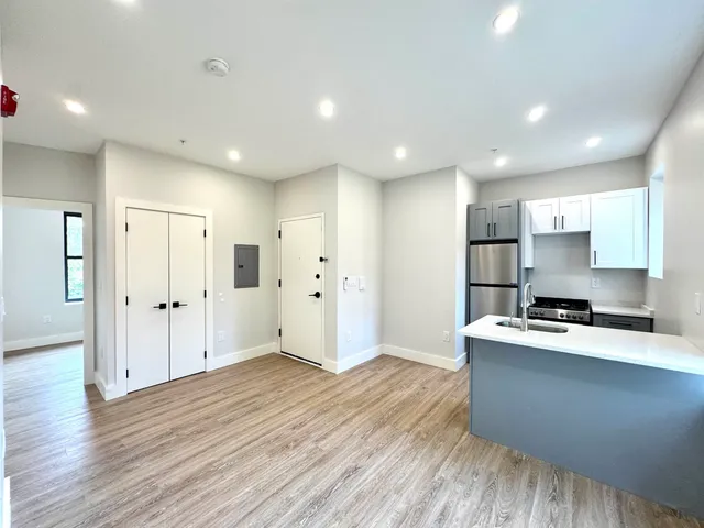 a kitchen with stainless steel appliances a refrigerator sink and cabinets