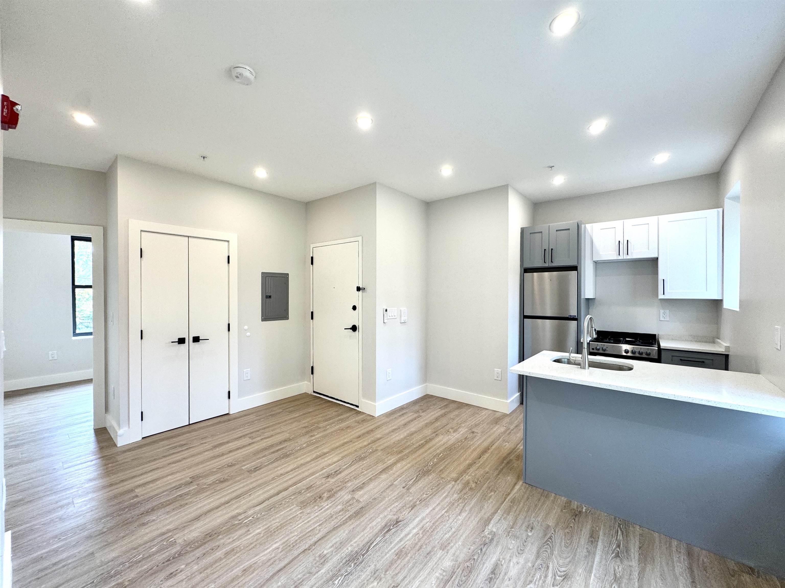 a kitchen with stainless steel appliances a refrigerator sink and cabinets