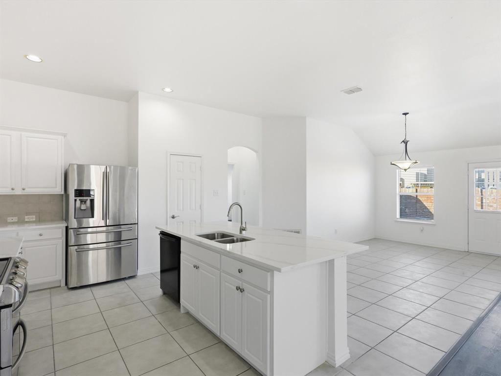 424 Shady Shore Lane Crowley, TX 76036 - Photo 12 of 40 a kitchen with a sink and refrigerator