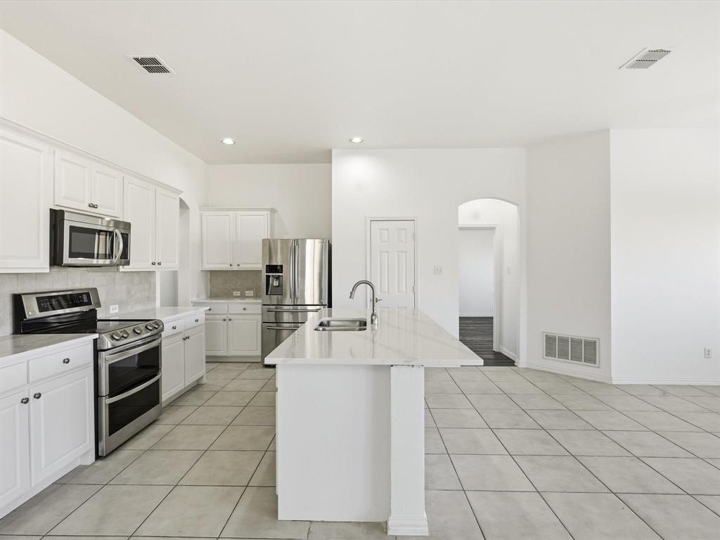 424 Shady Shore Lane Crowley, TX 76036 - Photo 13 of 40 a large white kitchen with cabinets