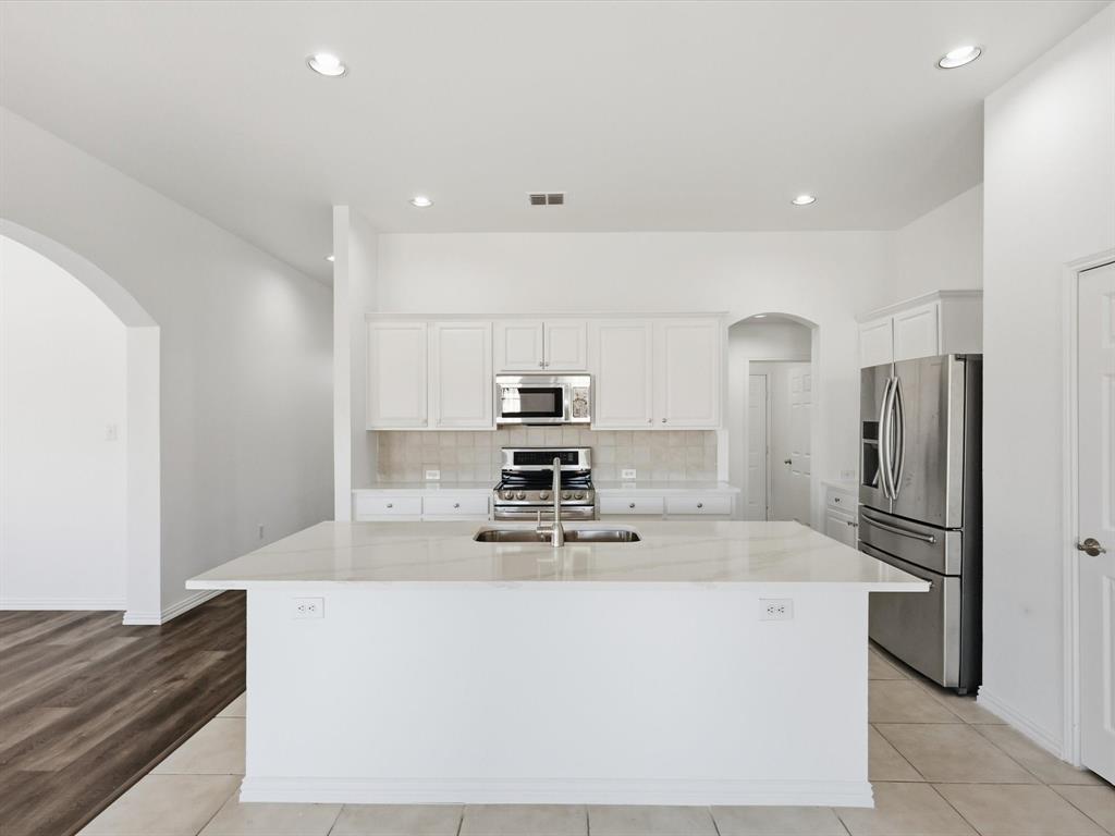 424 Shady Shore Lane Crowley, TX 76036 - Photo 15 of 40 a kitchen with stainless steel appliances a refrigerator and a stove