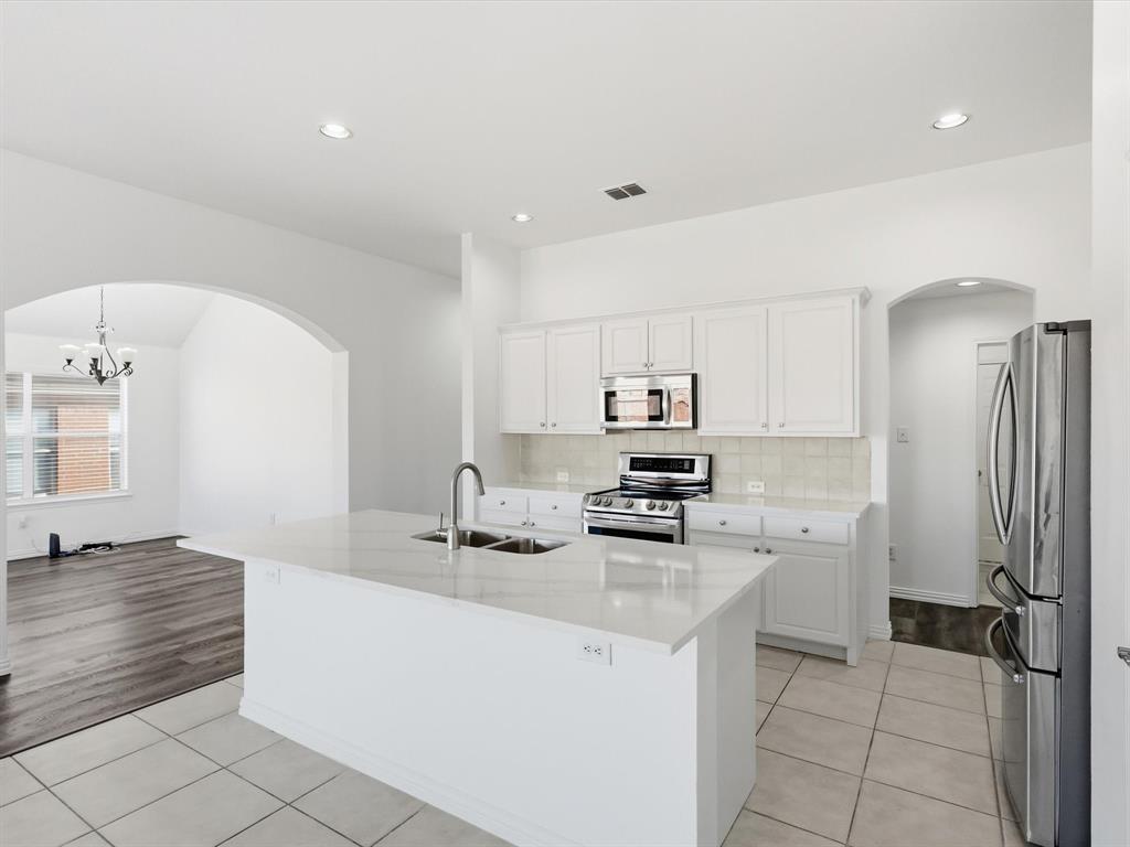 424 Shady Shore Lane Crowley, TX 76036 - Photo 16 of 40 a kitchen with stainless steel appliances a refrigerator sink and stove